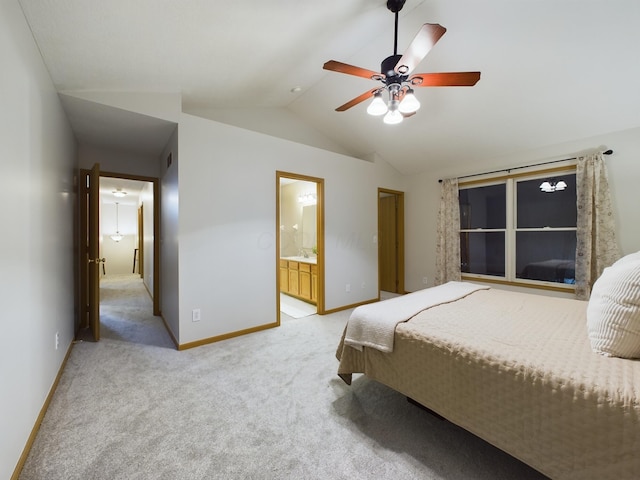 carpeted bedroom featuring ceiling fan, ensuite bathroom, and lofted ceiling