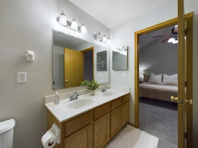 bathroom with toilet, ceiling fan, and vanity