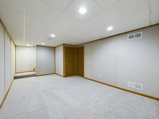 basement featuring light colored carpet