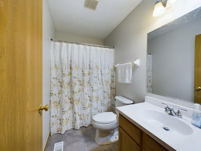 bathroom featuring toilet and vanity