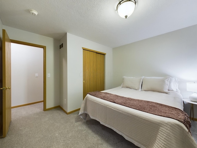 carpeted bedroom featuring a closet