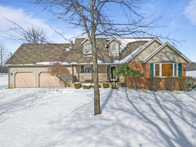 cape cod-style house with a garage and covered porch