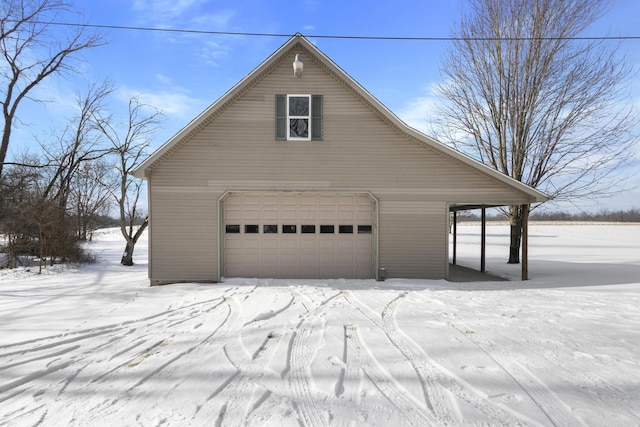 view of snowy exterior with a garage