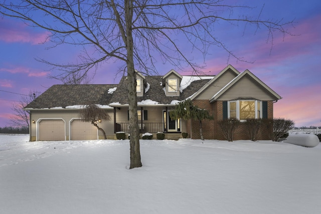 view of front of house featuring a porch and a garage