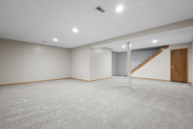 basement featuring light colored carpet