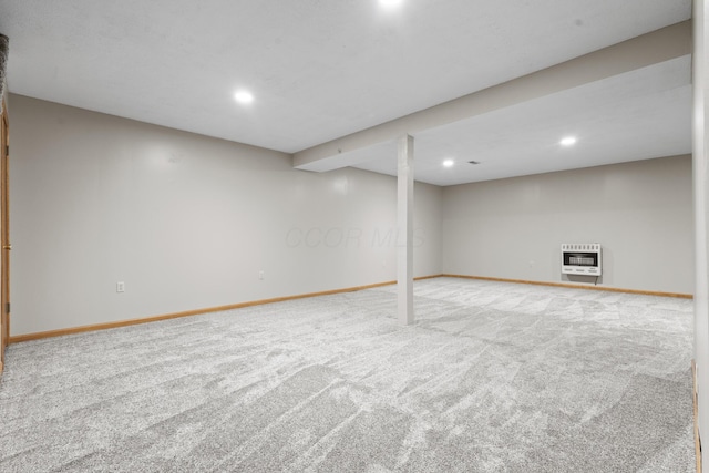 basement with light colored carpet and heating unit