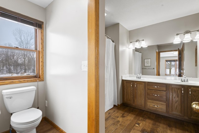 bathroom with hardwood / wood-style flooring, vanity, and toilet