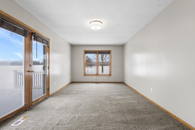 spare room with french doors and carpet