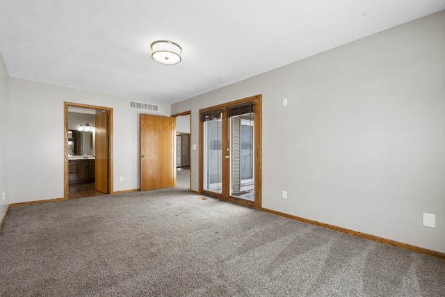 carpeted empty room with french doors