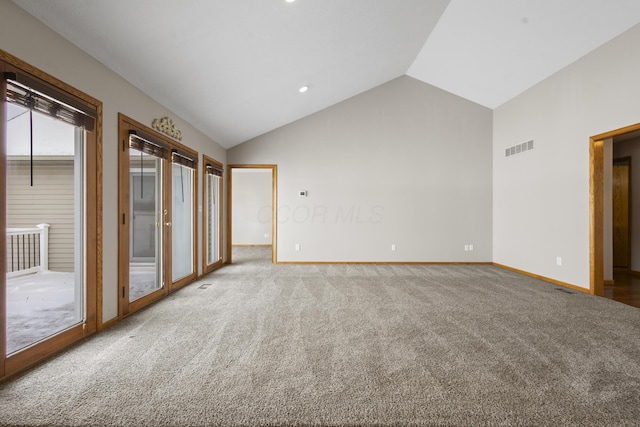 unfurnished room with vaulted ceiling, carpet floors, and french doors