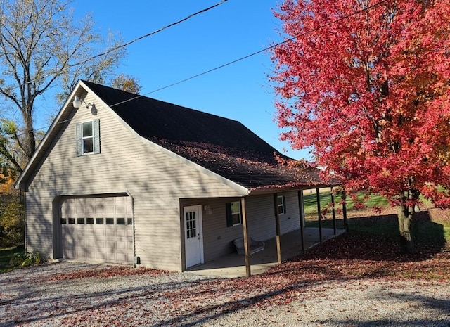 view of property exterior featuring a garage and a patio area