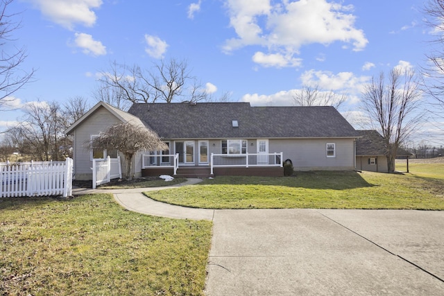 ranch-style home featuring a porch and a front yard