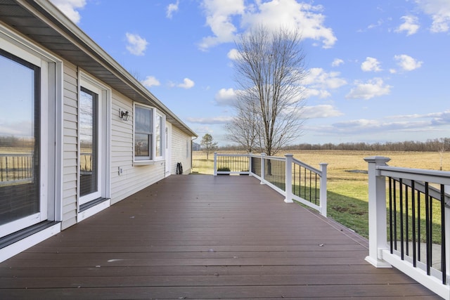 deck featuring a yard and a rural view