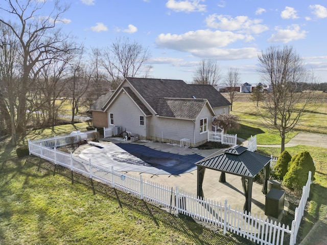 rear view of property with a gazebo and a patio area