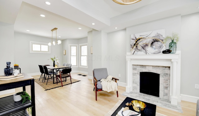 living room featuring a notable chandelier and light wood-type flooring