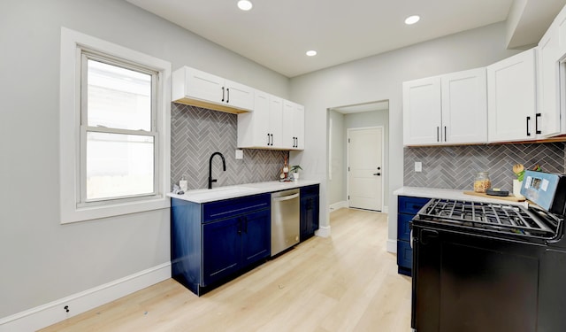 kitchen featuring sink, black gas stove, white cabinetry, stainless steel dishwasher, and light wood-type flooring