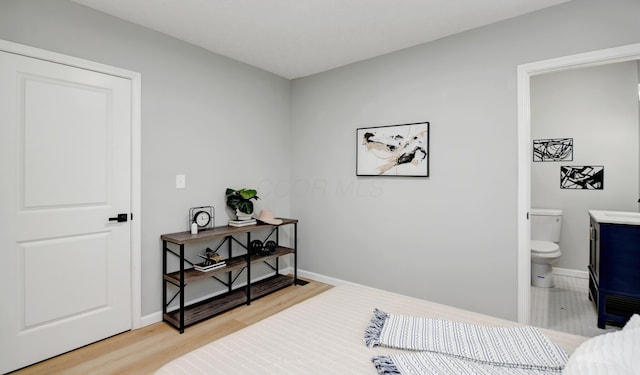 bedroom with wood-type flooring and ensuite bathroom