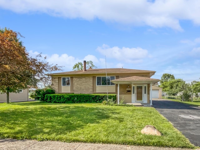 view of front of property with a garage and a front lawn