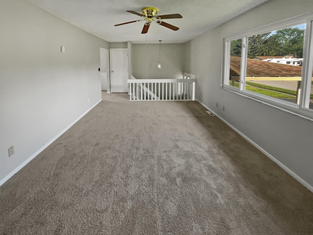 unfurnished room with ceiling fan and carpet flooring