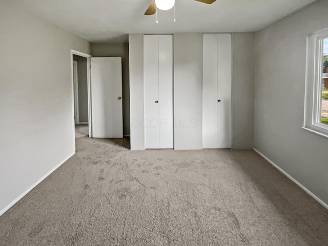 unfurnished bedroom featuring ceiling fan and light carpet