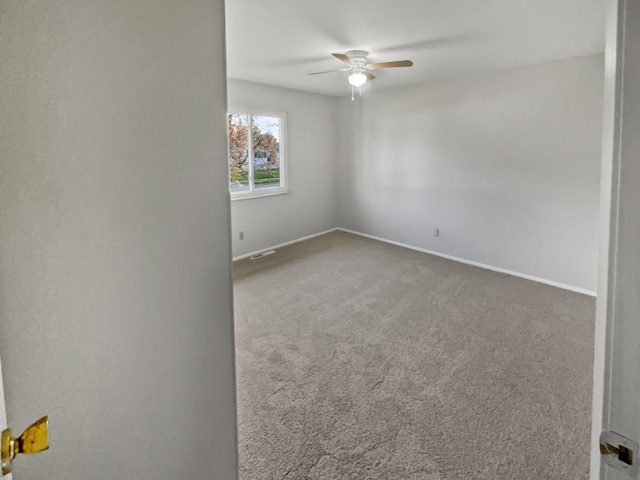 spare room with carpet floors and ceiling fan