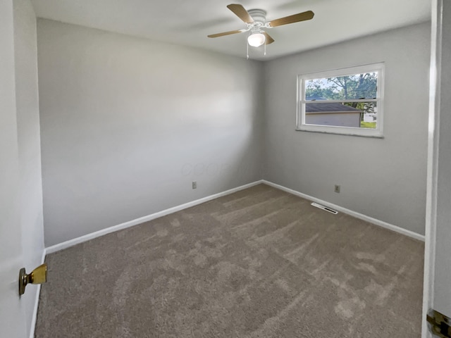 carpeted spare room featuring ceiling fan