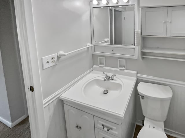 bathroom featuring toilet and vanity