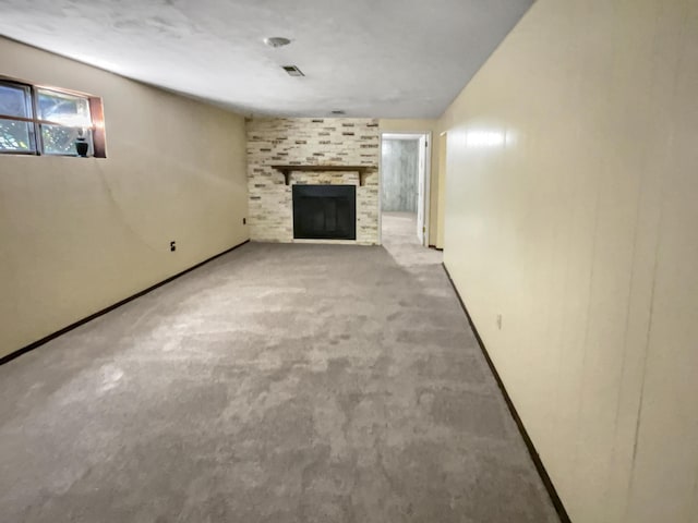 unfurnished living room featuring carpet floors and a fireplace