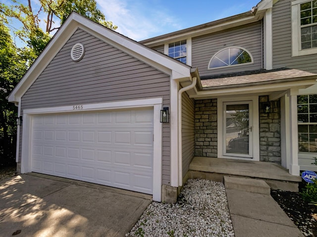 view of exterior entry with a garage