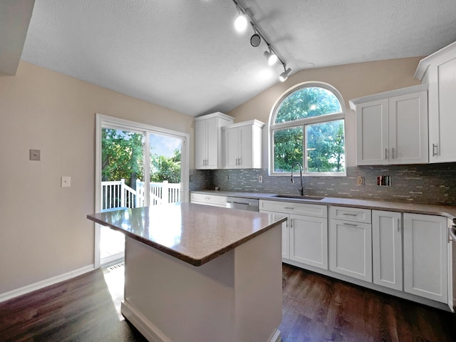 kitchen featuring sink, white cabinetry, and a center island