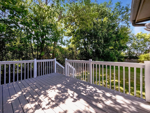 wooden deck featuring a yard