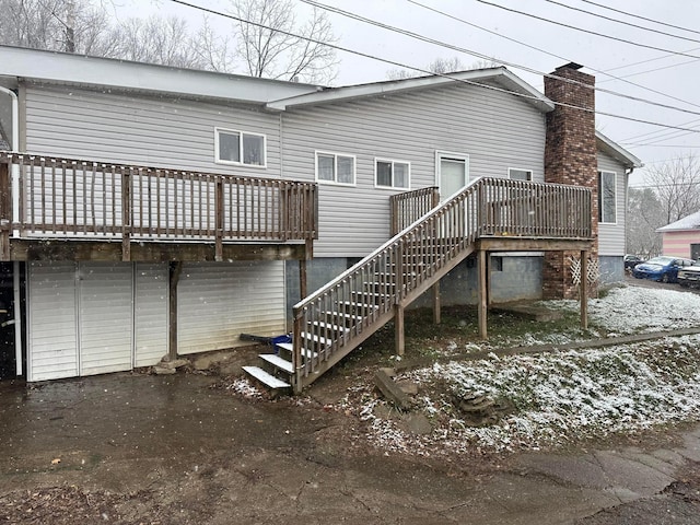 rear view of property featuring a wooden deck