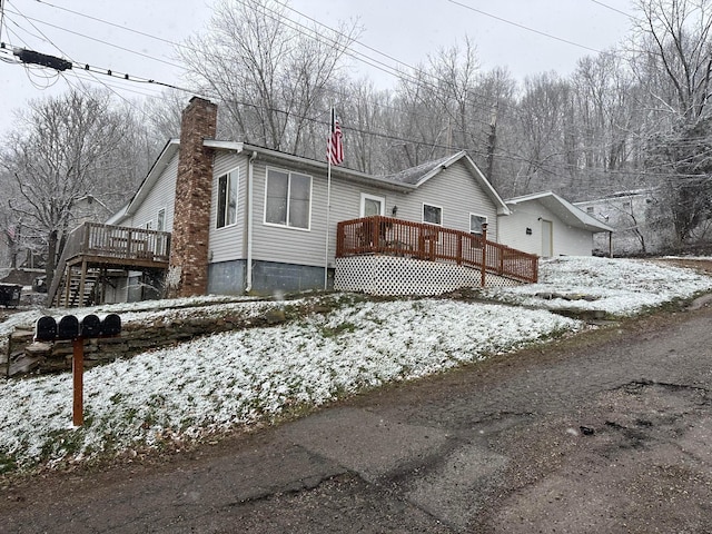 view of snow covered exterior featuring a wooden deck