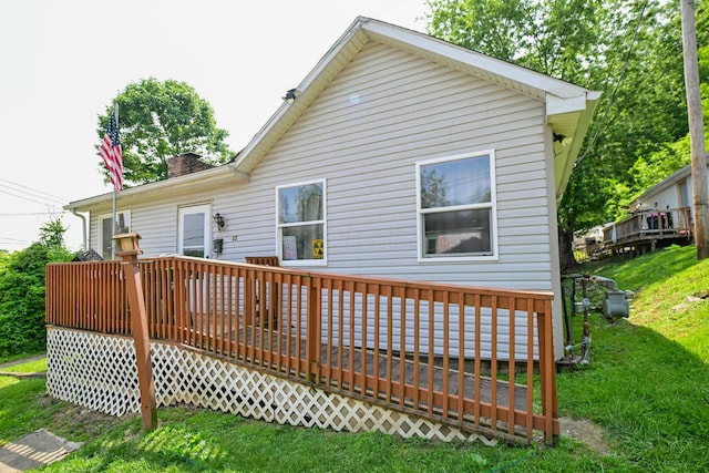 22 Fairlawn Ave, Glouster, OH 45732 - rear view of house featuring a wooden deck, a chimney, and a yard