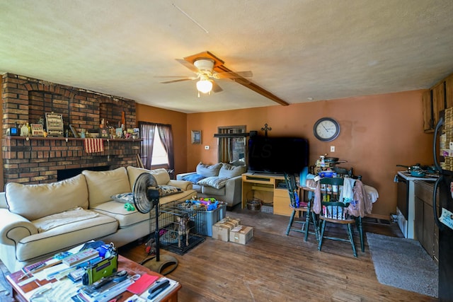 22 Fairlawn Ave, Glouster, OH 45732 - living room featuring a ceiling fan, wood finished floors, a fireplace, and a textured ceiling