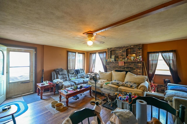 22 Fairlawn Ave, Glouster, OH 45732 - living room featuring a textured ceiling, wood finished floors, ceiling fan, and a brick fireplace