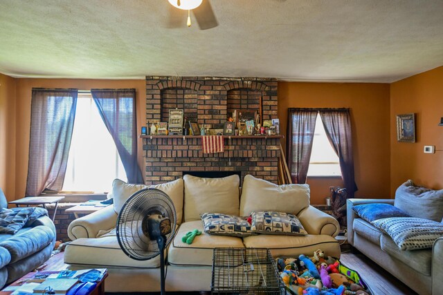 22 Fairlawn Ave, Glouster, OH 45732 - living area featuring a ceiling fan, a textured ceiling, and a fireplace