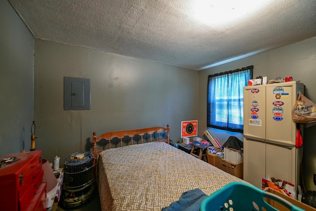 22 Fairlawn Ave, Glouster, OH 45732 - bedroom featuring electric panel, a textured ceiling, and freestanding refrigerator