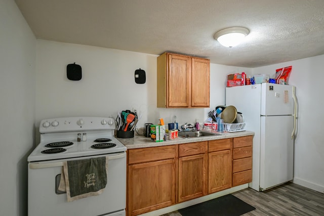 22 Fairlawn Ave, Glouster, OH 45732 - kitchen with white appliances, light wood-style floors, light countertops, a textured ceiling, and brown cabinetry