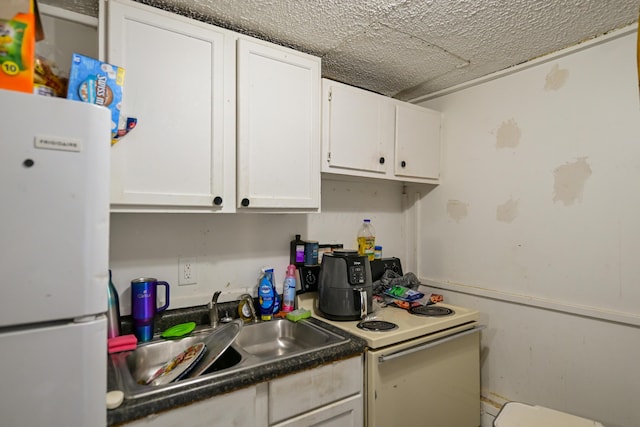 22 Fairlawn Ave, Glouster, OH 45732 - kitchen with white appliances, white cabinets, and dark countertops