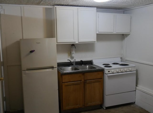 kitchen with white cabinets, sink, and white appliances