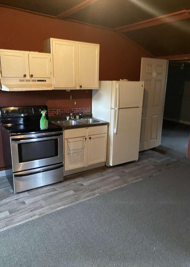 kitchen with white fridge, white cabinetry, sink, and stainless steel electric range