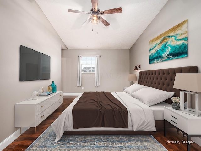 bedroom featuring a ceiling fan, lofted ceiling, baseboards, and wood finished floors