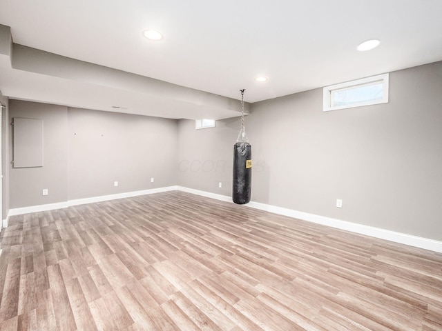 basement with recessed lighting, light wood-style flooring, and baseboards