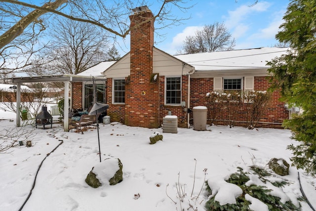 view of snow covered back of property