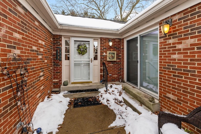 view of snow covered property entrance