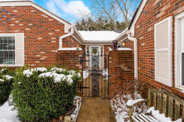 view of snow covered property entrance