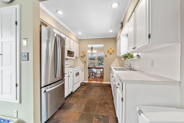 kitchen with white appliances, white cabinets, an inviting chandelier, sink, and backsplash