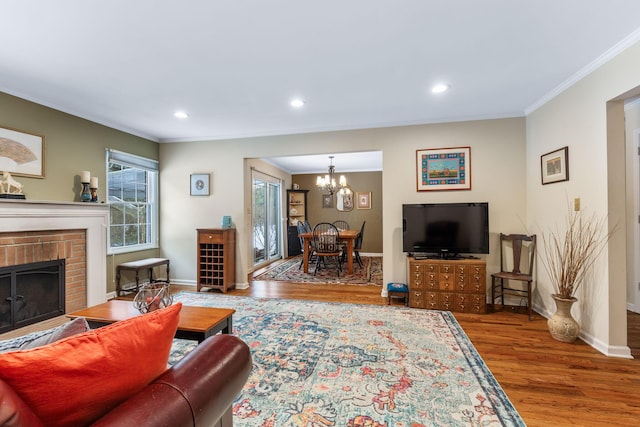 living room featuring crown molding, a fireplace, and wood-type flooring