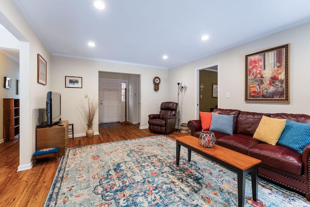 living room with wood-type flooring and crown molding